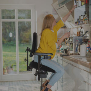 Woman using a Mercado chair to reach a kitchen shelf